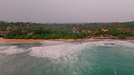 stunning aerial footage capturing the breathtaking weligama coastline bathed in the warm, golden hues of sunset.