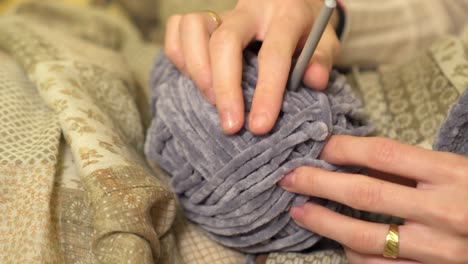 close-up of ball of wool with knitting needles ready for crocheting