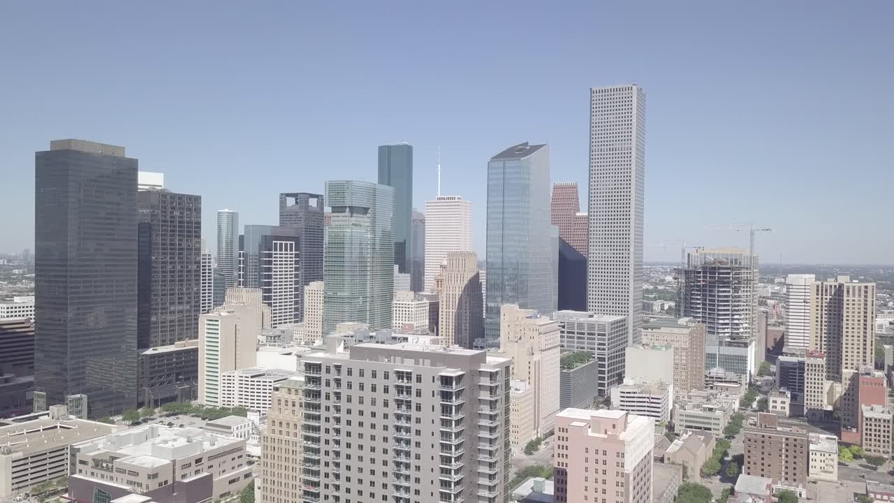 Aerial Opening Shot of Downtown Houston on a Sunny Day. Establishing Drone shoot of City of Houston Texas. Texas Industrial Symbol City of Houston. Houston City Skyline with blue clear sky. 4K