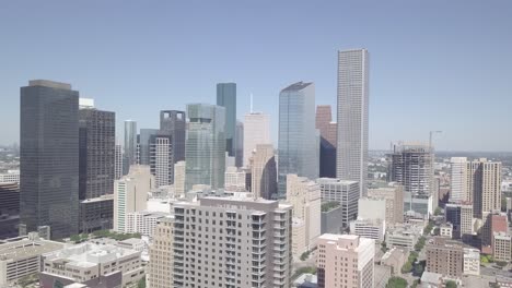 aerial opening shot of downtown houston on a sunny day. establishing drone shoot of city of houston texas. texas industrial symbol city of houston. houston city skyline with blue clear sky. 4k