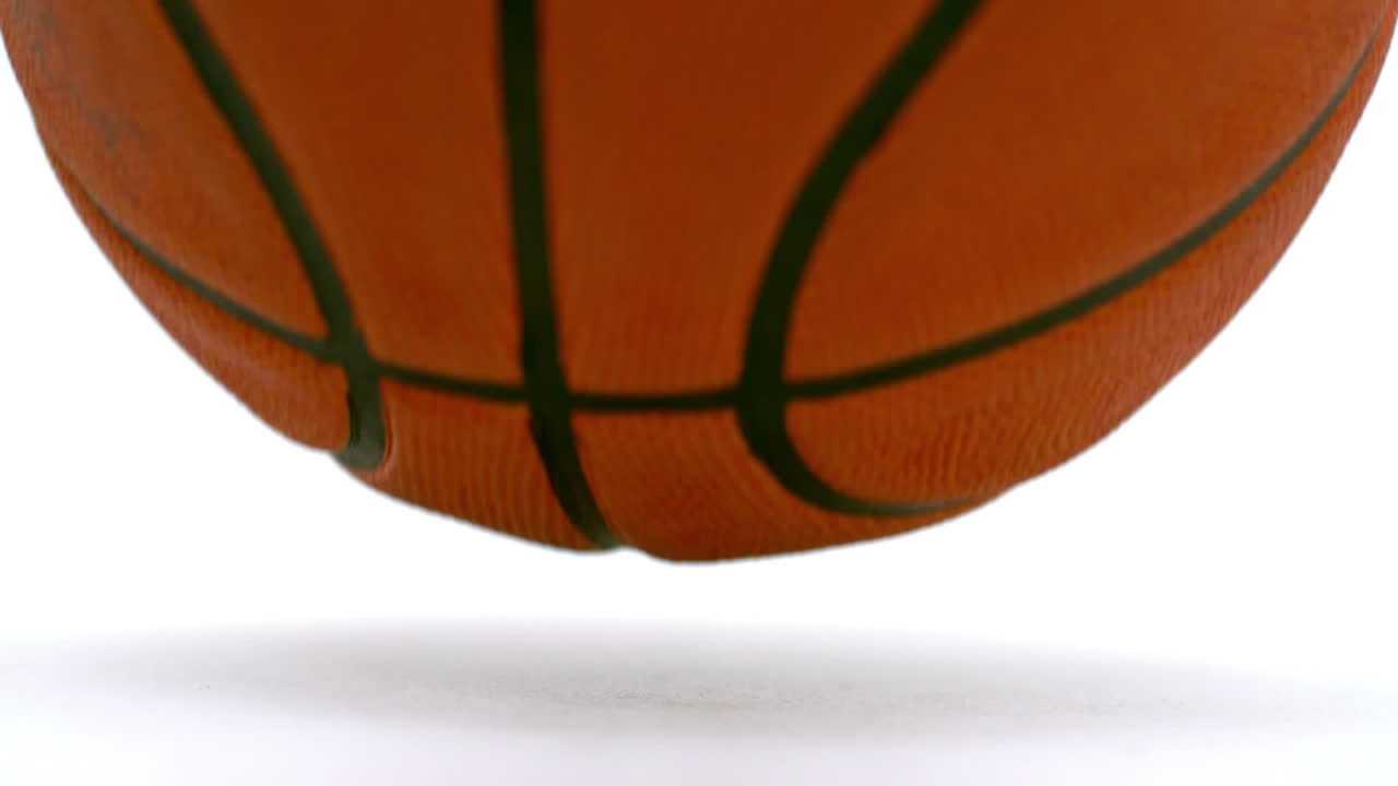 Animation of yellow zigzag lines over bouncing basketball, on white background