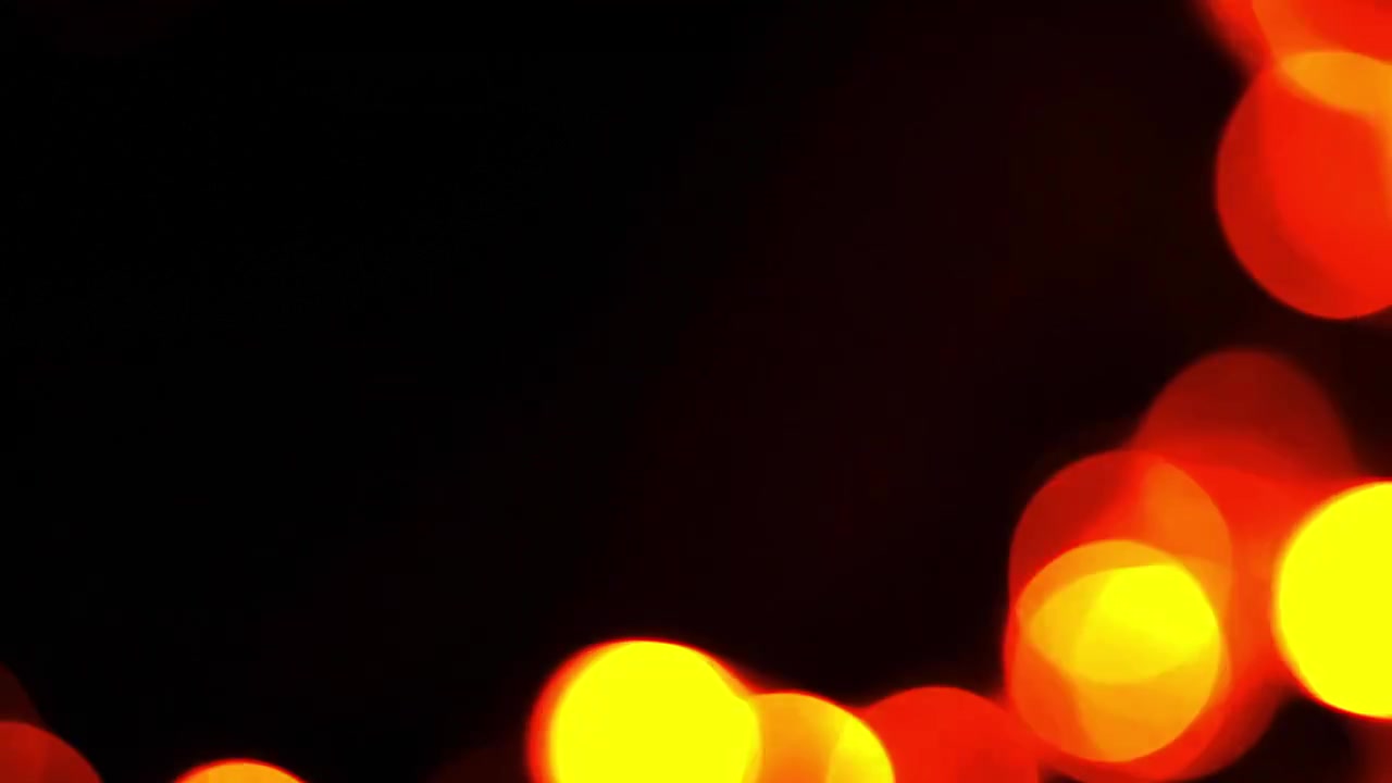 Abstrakt bakgrunn av glødende røde og oransje bokeh-lys