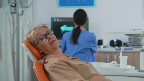 senior woman looking on camera waiting on dental clinic