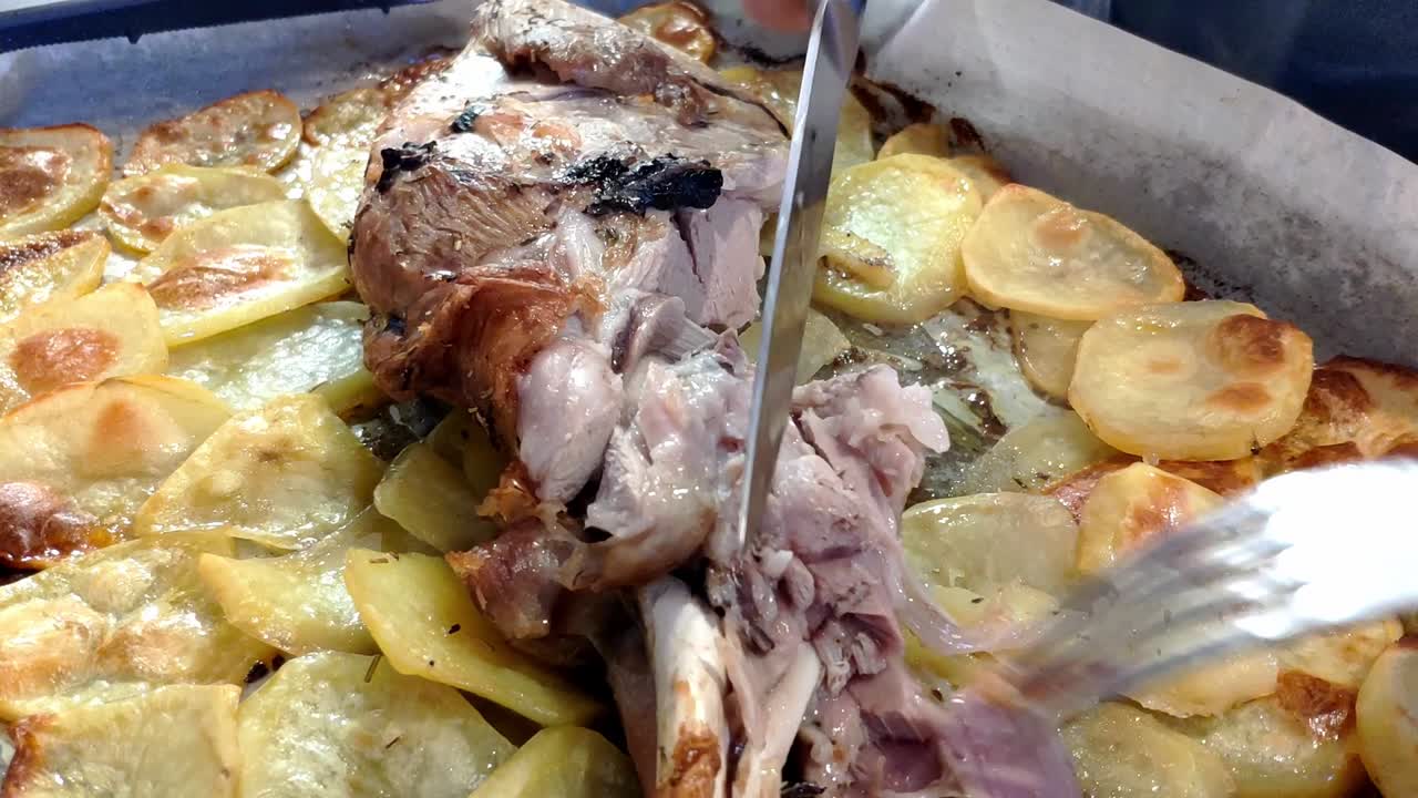 bandeja con pierna de cordero asada y patatas