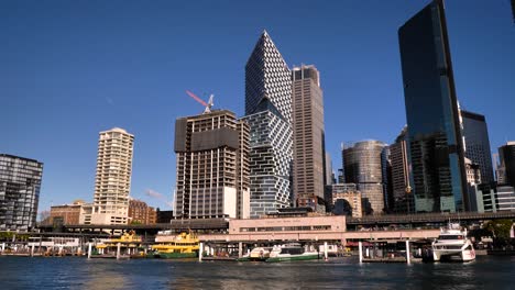 sydney harbor cityscape with modern buildings and ferries