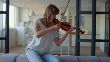Teenage-girl-playing-violin.-Violinist-playing-chords-on-musical-instrument