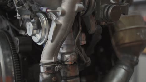 Car-engine-to-be-repaired-by-mechanic-close-up-shot