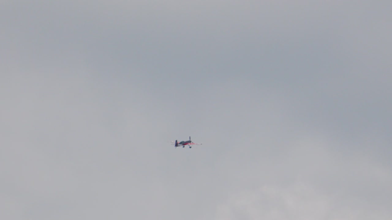 Stunt Plane Spinning Multiple Times in Slow Motion Before Beginning Ascent. Single Engine Classic Aerobatic Aircraft in Flight