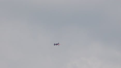 stunt plane spinning multiple times in slow motion before beginning ascent. single engine classic aerobatic aircraft in flight
