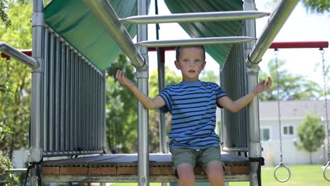 slow motion shot of a young boy playing on the monkey bars on a playground set in his backyard-3