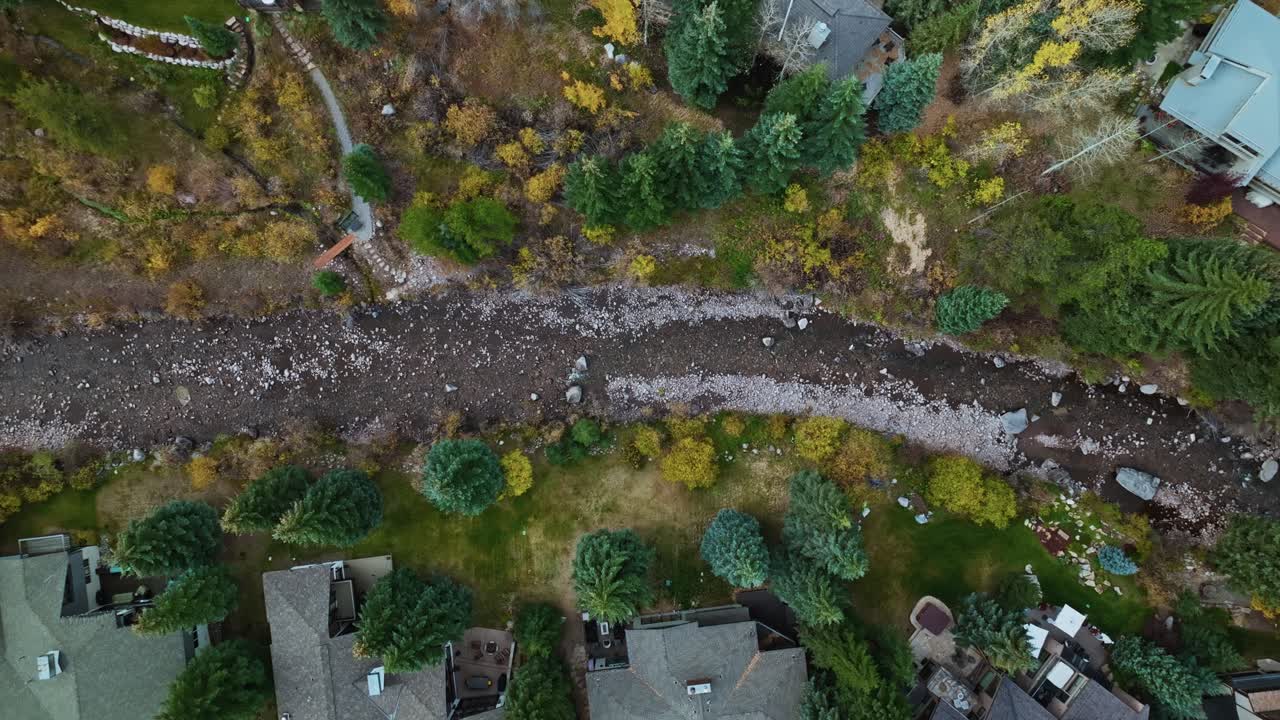 Aerial View of River Running Through Upscale Residential Area in Autumn