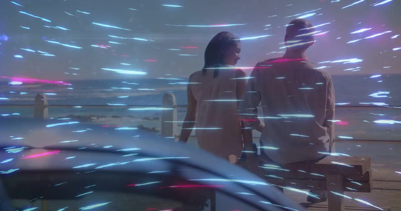 Sitting couple talking on pier bench in light dress and shirt, light streaks crossing curved glass