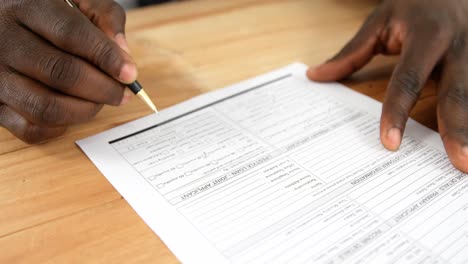 agent sitting at desk filling mortgage contract form