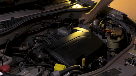 removing the cover of the radiator reservoir to check if the water needs to be filled