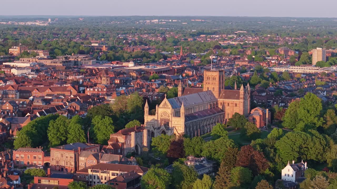 A cinematic drone captures the St Albans area in warm afternoon sunlight, highlighting historic architecture, streets, and scenic urban and natural landscapes