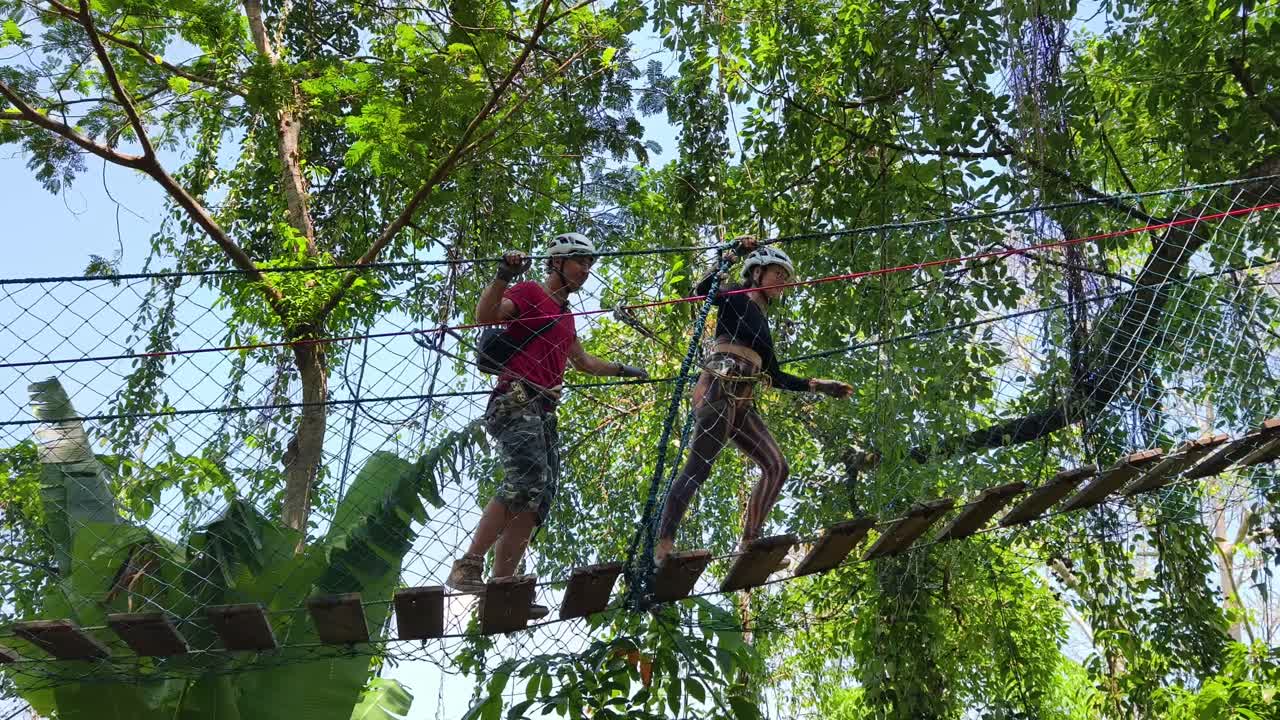 Couple enjoying a zip line adventure in a lush forest