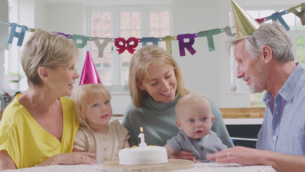 집 에서 첫 번째 생일 파티 에서 손자 에게 생일 축하 를 노래 하는 어머니 와 함께 할아버지 와 할머니