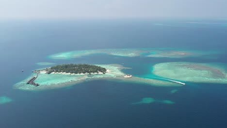 amazing aerial view of maldives islands with a boat, turquoise water, palms and white sand