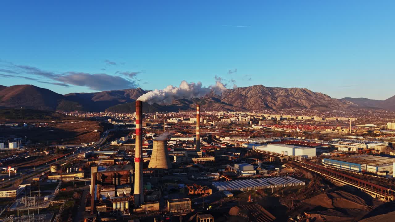 Industrial area with smokestacks and buildings in evening light