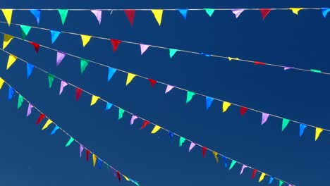 multicolored flags on the blue sky.