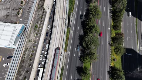 aerial view of city road with traffic and train