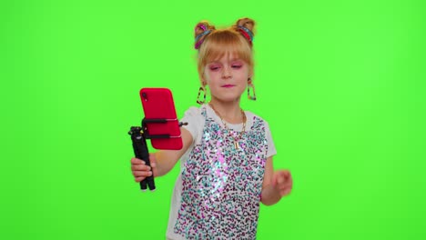 Happy-funky-blogger-child-kid-girl,-recording-funny-dancing-video-on-smartphone-for-social-network