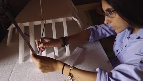 woman student working as architect building housing model mock-up