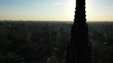 an aerial shot of a cathedral's steeple, which was taken at sunrise