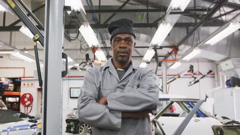 African-American-male-car-mechanic-crossing-his-arms-and-looking-at-camera