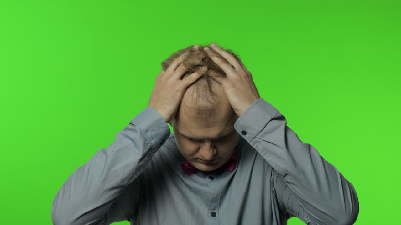 Flu-sick man feeling unwell, suffering headache, rubbing head to relieve pain, migraine, stress