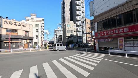 vehicles and pedestrians crossing an urban intersection.