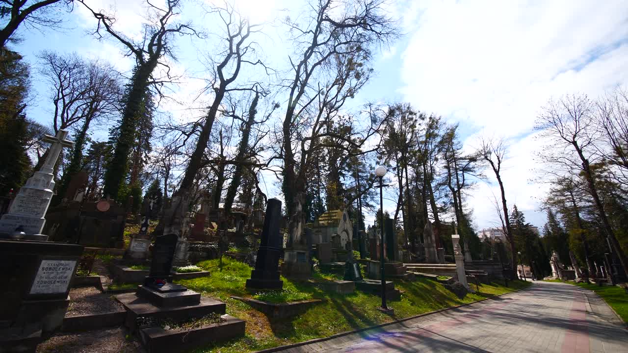 Graves tombs in beautiful cemetery graveyard with leafless trees Lychakiv Lviv Ukraine