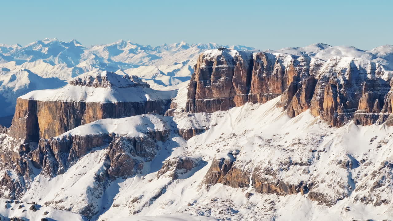 Aerial drone view of the Marmolada mountain in the Dolomites, northeastern Italy with the blue sky on the background