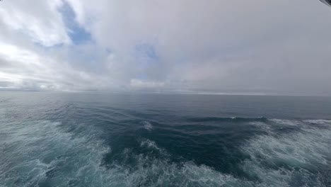 forward through the handrails of a cruise ship to view the ocean