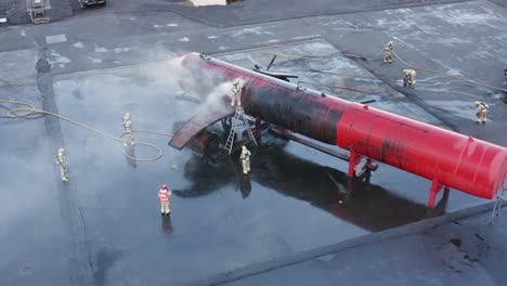 smoke exits from dummy aircraft during fire drill training on airport