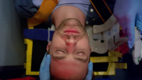 emergency doctors in gloves providing first aid help to man on stretchers