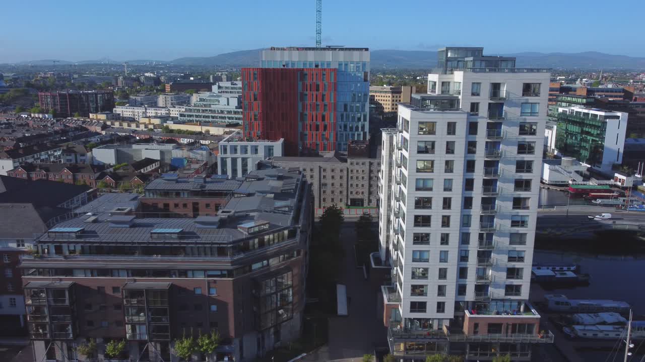 Aerial view of Grand Canal Docks in Dublin, city panorama and Dublin hills in the horizon.