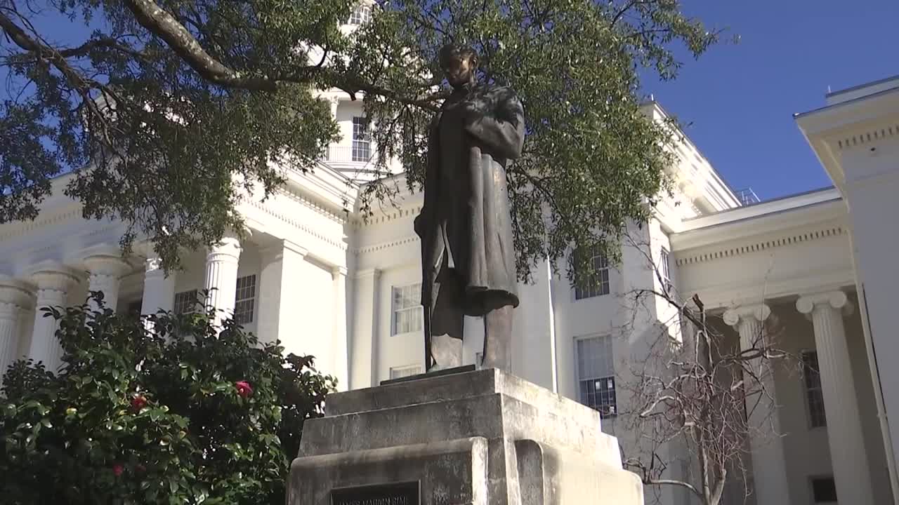 TILT SHOT OF JAMES SIMS STATUE IN FRONT OF ALABAMA STATE CAPITOL