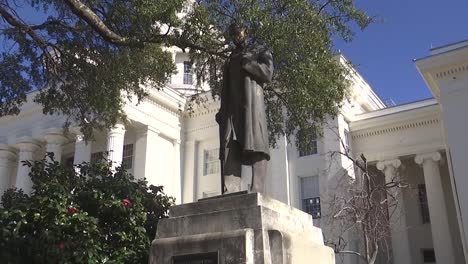 tilt shot of james sims statue in front of alabama state capitol