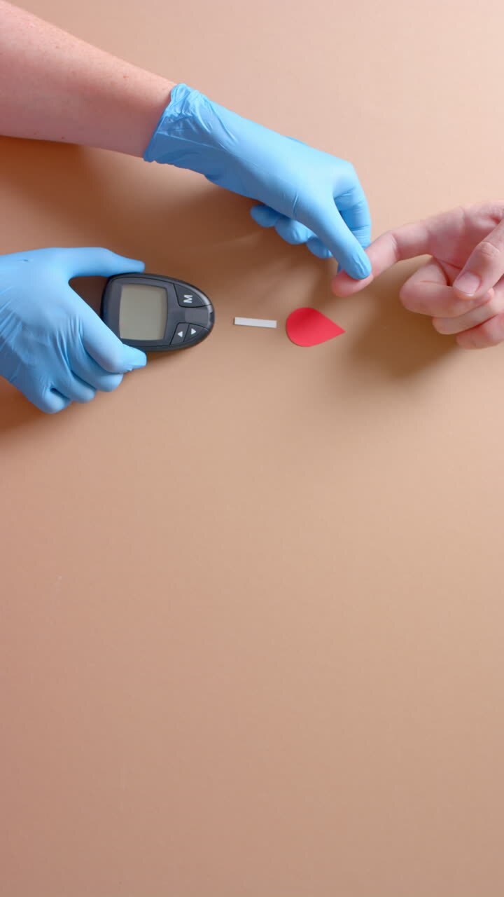 Vertical video of hands of caucasian doctor and patient checking blood sugar level, slow motion