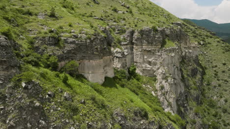 revolve on craggy mountains over the river flowing near khertvisi fortress in georgia