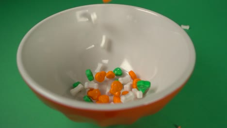 bones and skulls candy shaped falling on a plate