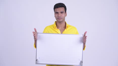 joven y guapo hombre de negocios indio con pizarra blanca