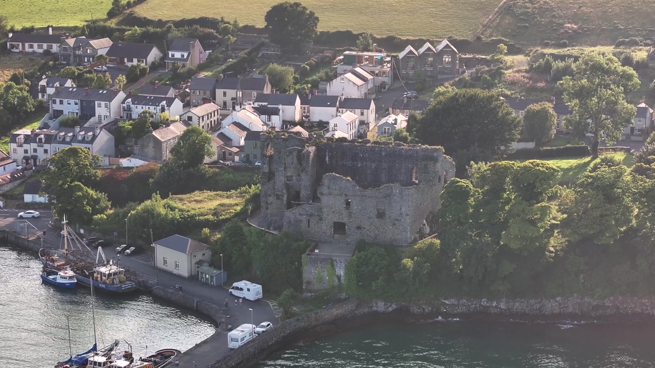 Ruins of Carlingford Castle on coast. Small picturesque town in Ireland. Drone