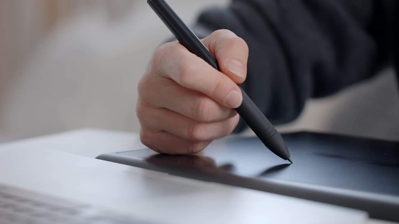 Person using a graphics tablet and stylus