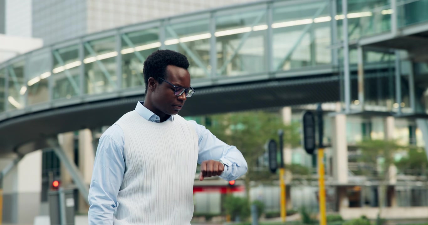 Young Professional Man Walking and Checking Time in City