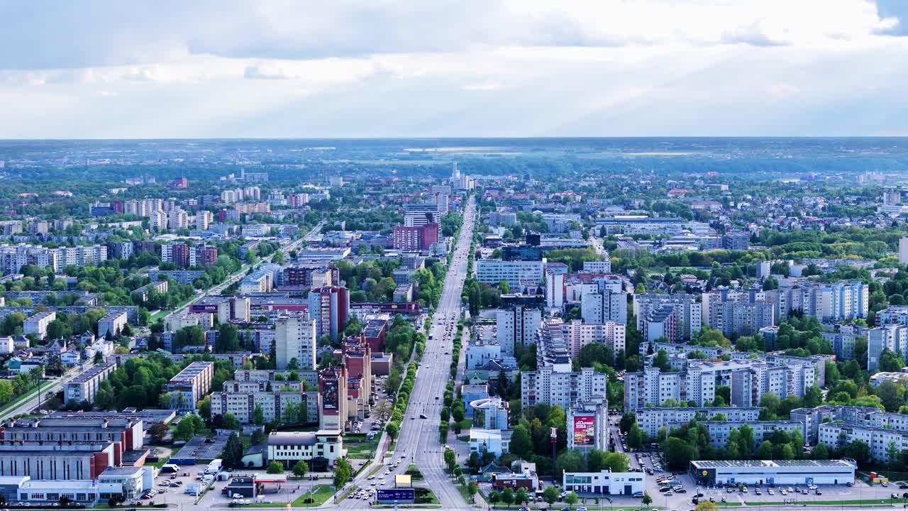 High-altitude drone footage of Savanoriai Avenue stretching through Kaunas, highlighting traffic flow and city infrastructure