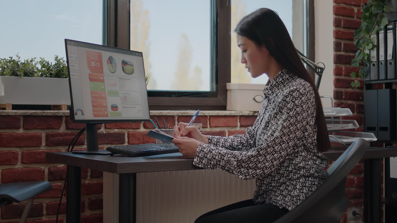 Entrepreneur analyzing annual data on documents and computer