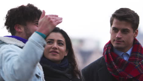 amigos caminando por la orilla sur en una visita de invierno a londres
