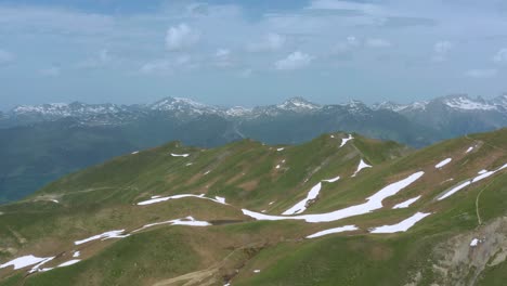 scenery of snowy slopes mountains near little saint bernard pass with mont blanc at background in france. - aerial wide shot